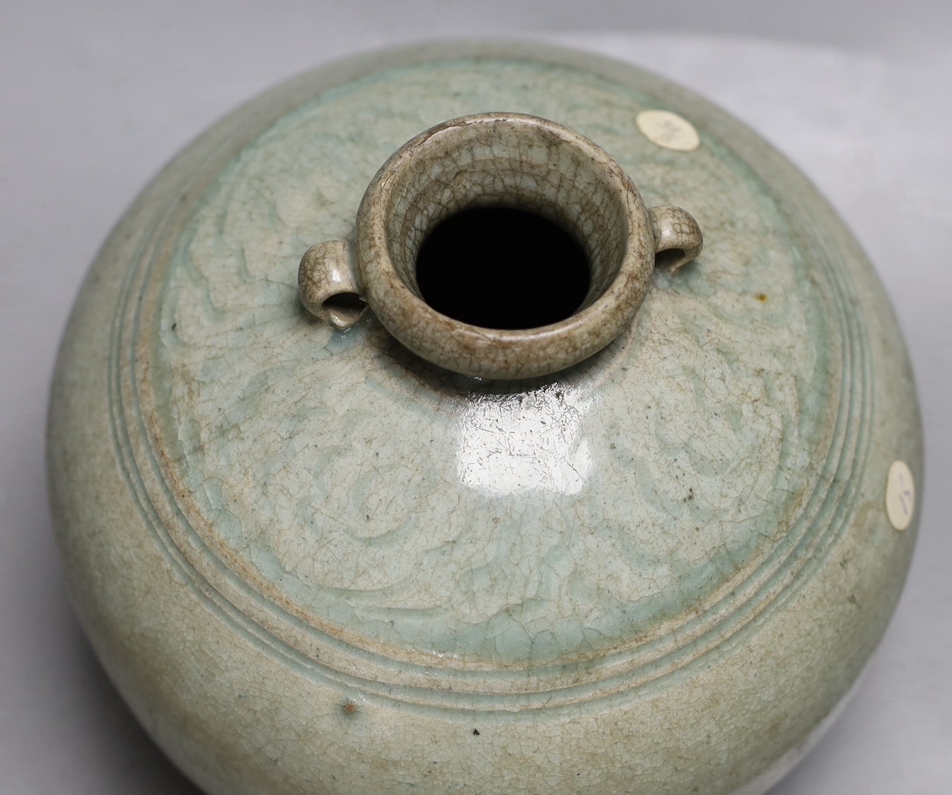 A Thai Sawankhalok green glazed ring handled jar, 15th century
